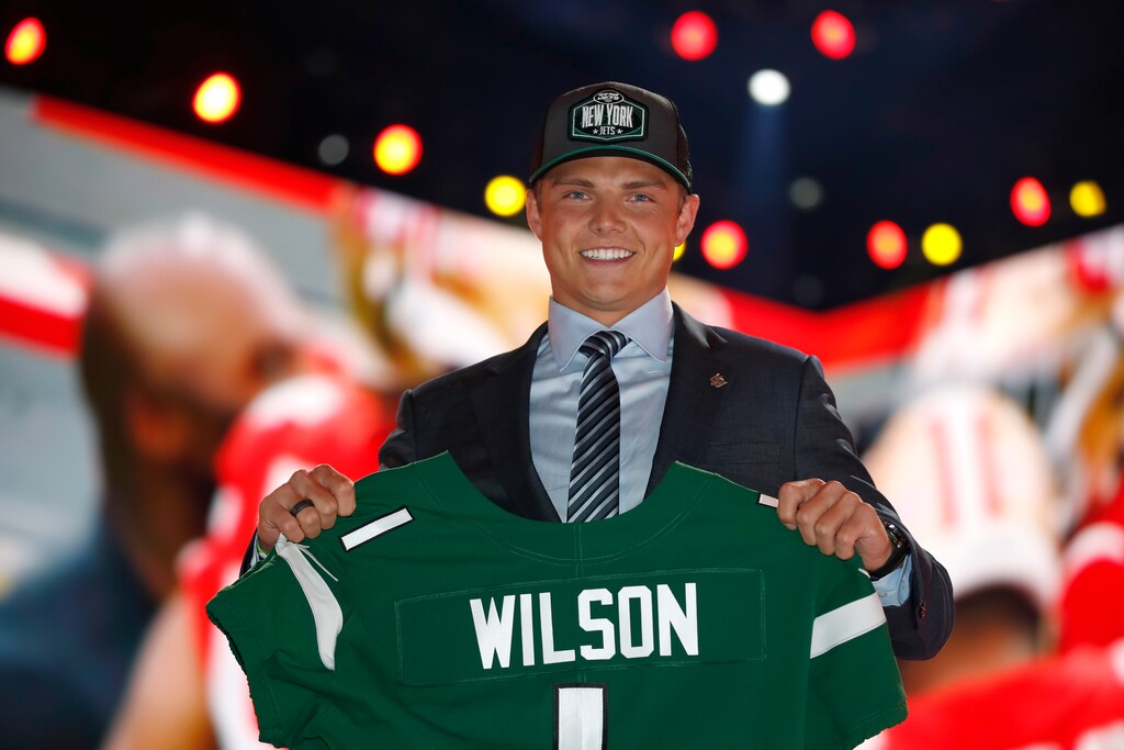 (Jeff Haynes | AP Images for Panini) BYU quarterback Zach Wilson holds a New York Jets jersey after being selected second overall by the team in the first round of the NFL football draft, Thursday, April 29, 2021, in Cleveland.