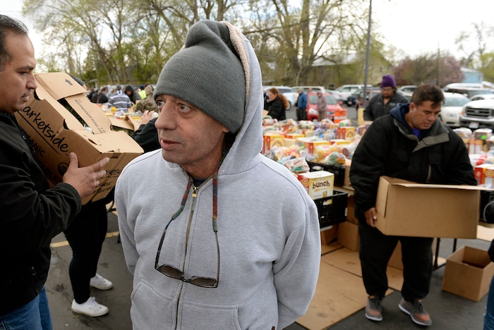 (Al Hartmann | The Salt Lake Tribune)
Steve Riddell who said that he recently lost his job but doesn't qualify for food stamps waits to recieve a box of food to get him and his wife by. Behind him volunteers of the Utah Food Bank pack food boxes in the parking lot of the LDS Church at 1860 S. 300 E. in Salt Lake City Friday April 13. It's one of 18 locations the bank operates to get food out to the food insecure. Walmart, Feeding America and Utah Food Bank are teaming up during the month of April to fight hunger through an online and in-store donation campaign.