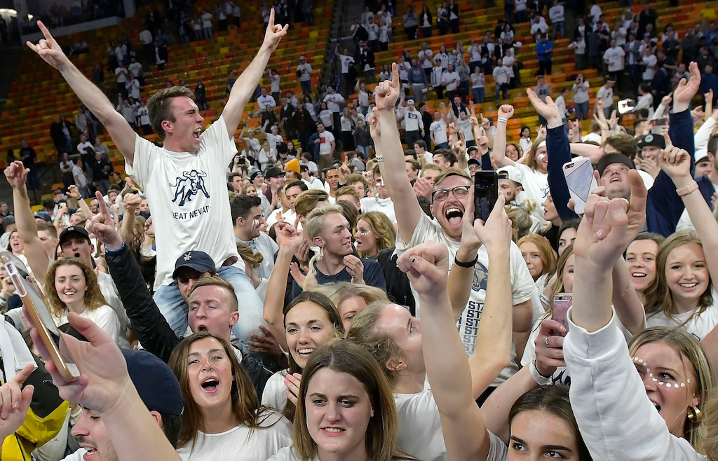 (Eli Lucero | The Herald Journal) Fans celebrate on the court after Utah State defeated No. 12 Nevada 81-76 in an NCAA college basketball game Saturday, March 2, 2019, in Logan, Utah.