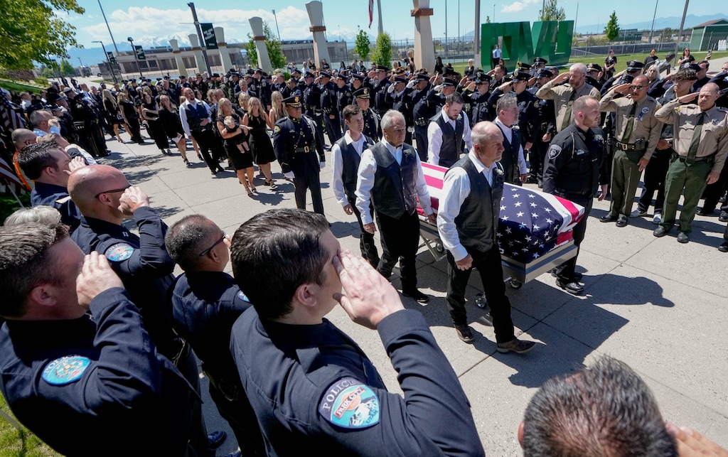 (Francisco Kjolseth  |  The Salt Lake Tribune) Pallbearers carry the casket of Santaquin police Sgt. Bill Hooser after services at the UCCU Center at Utah Valley University on Monday, May 13, 2024.