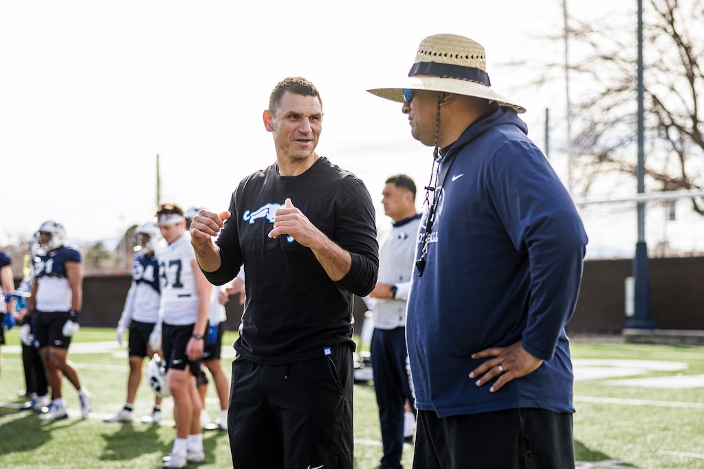 (Nate Edwards|BYU Athletics) BYU defensive coordinator Kelly Poppinga speaks with BYU head coach Kalani Sitake.