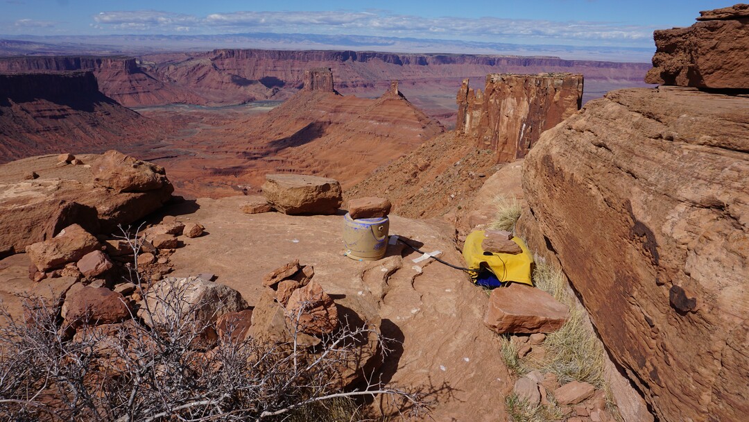(Nathan Richman | The New York Times) A photo by Nathan Richman of a seismometer, under a bucket for protection from weather, and attached recording equipment that he placed at the base of Castleton Tower, Castle Valley, Utah, March of 2018. Castleton Tower taps into the earth’s natural vibrations, and pulsates at about the rate of a human heartbeat.