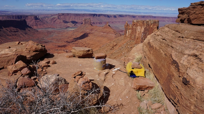 (Nathan Richman | The New York Times) A photo by Nathan Richman of a seismometer, under a bucket for protection from weather, and attached recording equipment that he placed at the base of Castleton Tower, Castle Valley, Utah, March of 2018. Castleton Tower taps into the earth’s natural vibrations, and pulsates at about the rate of a human heartbeat.