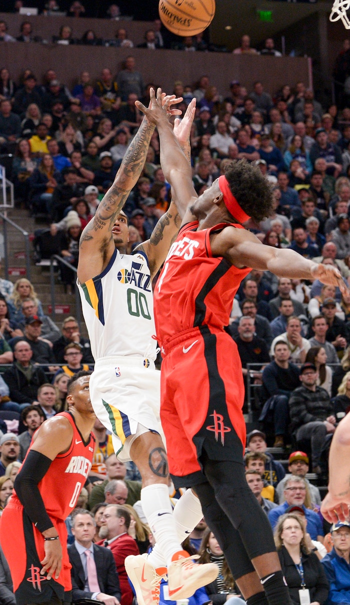 (Leah Hogsten  |  The Salt Lake Tribune)  Utah Jazz guard Jordan Clarkson (00) shoots around Houston Rockets forward Danuel House Jr. (4). The Utah Jazz host the Houston Rockets at Vivint Arena, Feb. 22, 2020.