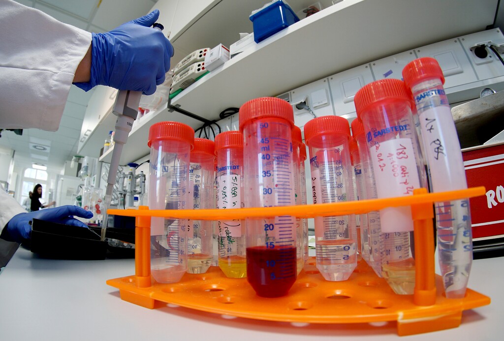 (Michael Sohn | AP file photo) A lab assistant works on samples after an AP interview with Christian Drosten, director of the institute for virology of Berlin's Charite hospital on his researches on the coronavirus in Berlin, Germany, Tuesday, Jan. 21, 2020.
