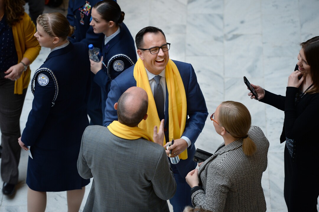 (Scott Sommerdorf   |  The Salt Lake Tribune)   Speaker of the House Greg Hughes, R-Draper laughs while speaking with Lt. Governor Spencer Cox, lower left, during a charter schools event that gave everyone a yellow scarf to wear, Thursday, January 25, 2018.