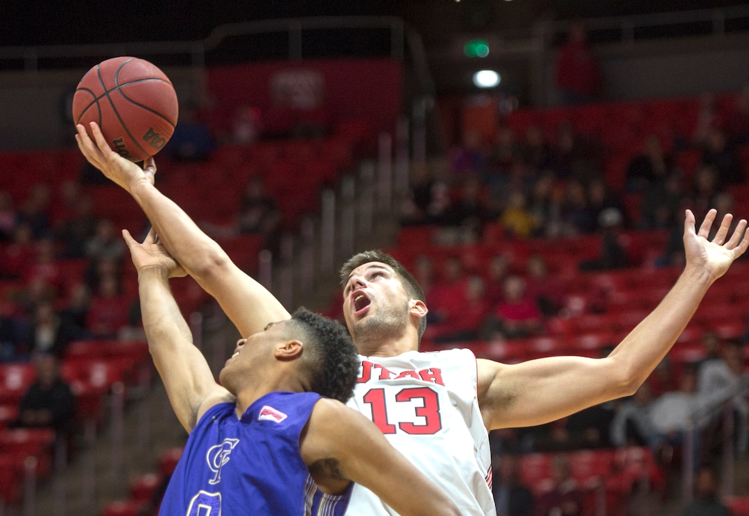 (Rick Egan  |  The Salt Lake Tribune)  Utah Utes forward Novak Topalovic (13) grabs a rebound, as Jalen Galloway (0) College of Idaho, defends, in basketball action, between the Utah Utes and the College of Idaho Yotes at the Jon M. Huntsman Center, Thursday, Nov. 1, 2018.