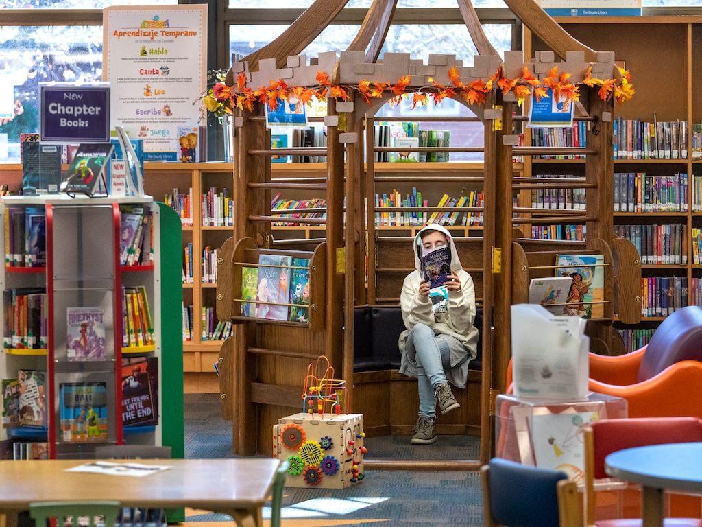(Leah Hogsten | The Salt Lake Tribune) Lily Aguilar, 10, reads in the Children's Section of the Ruth Vine Tyler Library, Nov. 23, 2021. 