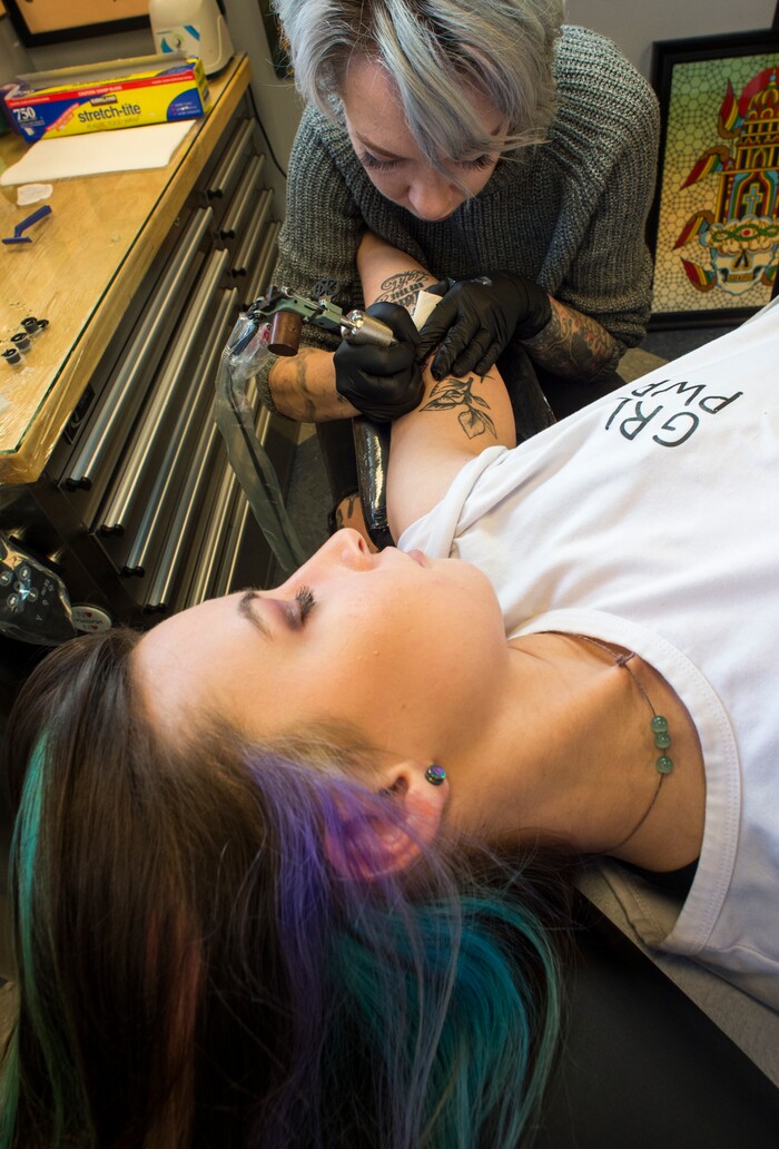 (Rick Egan | The Salt Lake Tribune) Nyx Porter gets a tattoo from Ashley Love, at the Yellow Rose Tattoo, during a flash tattoo event where all proceeds go to the Rape Recovery Center of Utah. It's part of a national event where tattoo shops raise money for sexual assault victims. Sunday, June 10, 2018.