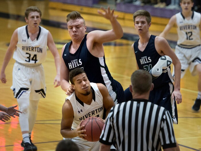 Scott Sommerdorf | The Salt Lake TribuneCopper Hills' Trevon Allfrey comes down on top of Tristyn Hymas of Riverton during first half play. Copper Hills defeated Riverton 54-50, Friday, February, 2, 2018. 