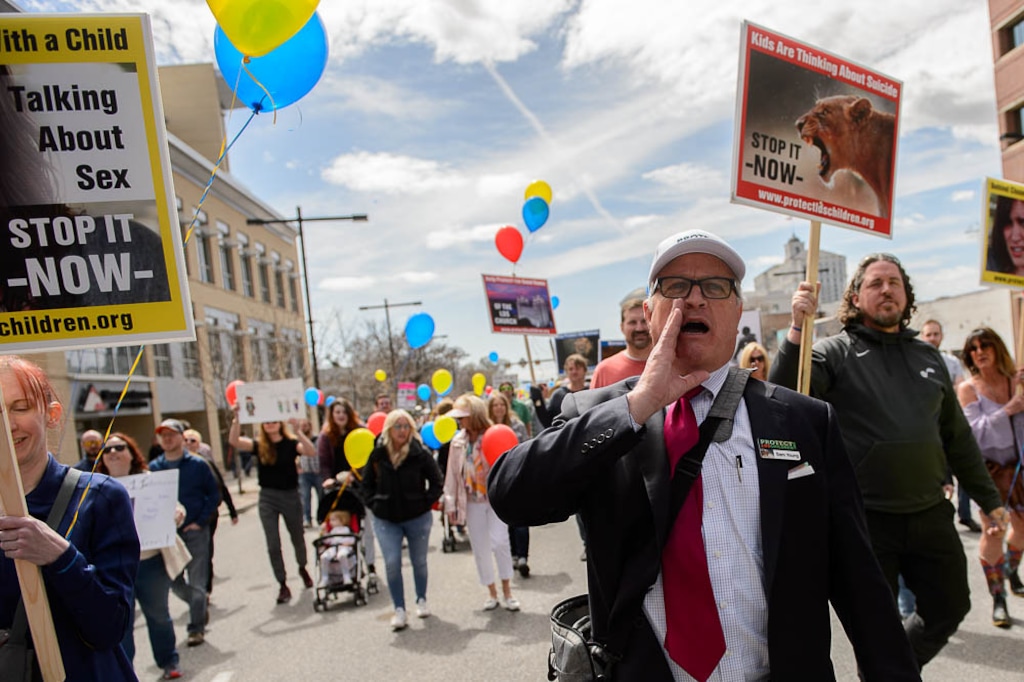 (Trent Nelson | The Salt Lake Tribune)  
Sam Young leads a march in downtown Salt Lake City to urge Latter-day Saint leaders to end bishops meeting one on one with youths for interviews. Friday March 30, 2018.