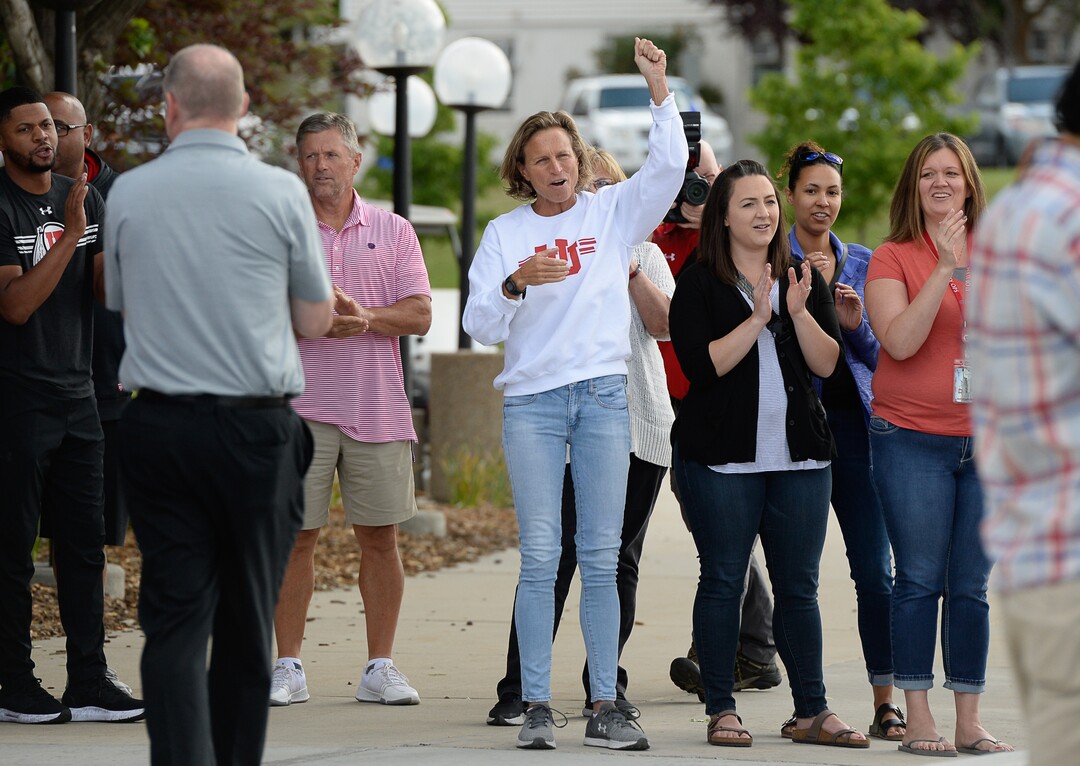 (Francisco Kjolseth  |  The Salt Lake Tribune)  University of Utah staff applaud athletic director Chris Hill at the Huntsman Center on Friday, June 1, 2018, as he says goodbye and climbs aboard a red Ute-branded Holiday Motor coach bus after 31 years on the job.