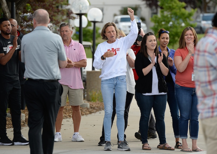 (Francisco Kjolseth  |  The Salt Lake Tribune)  University of Utah staff applaud athletic director Chris Hill at the Huntsman Center on Friday, June 1, 2018, as he says goodbye and climbs aboard a red Ute-branded Holiday Motor coach bus after 31 years on the job.