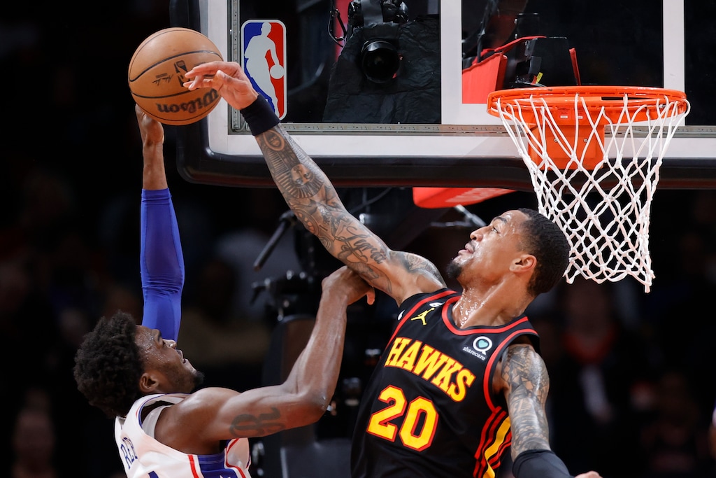 (Alex Slitz | AP Photo) Atlanta Hawks forward John Collins, right, blocks a shot from Philadelphia 76ers forward Paul Reed during the first half of an NBA basketball game Friday, April 7, 2023, in Atlanta.