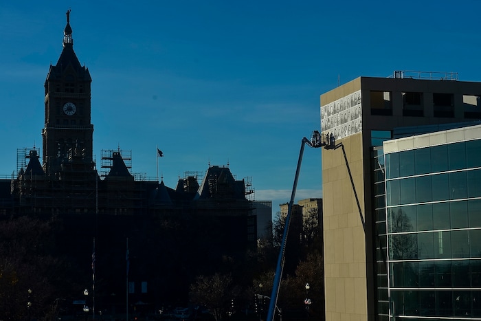 (Chris Detrick  |  The Salt Lake Tribune)  Alexander Pierre and Jaime Scatena hang portraits of Inside Out/Dreamers Project participants on the Salt Lake City Public Library Tuesday, November 21, 2017.  The Inside Out Project is a global participatory art project that gives everyone the opportunity to share their portrait and express what they stand for. In Utah, the future of more than 10,500 DACA recipients is being threatened by President TrumpÕs decision to end the popular and successful DACA program. The Center for American Progress estimates that Utah has 19,000 Dream Act-eligible individuals in the workforce and would see annual state GDP gains of $206 million from passage of the Dream Act.