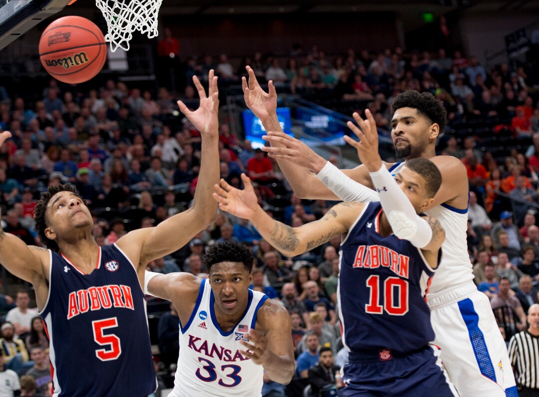 (Leah Hogsten  | The Salt Lake Tribune)  Auburn and Kansas players scramble for the ball as they face off in the second round of the NCAA tournament in Salt Lake City on Saturday, March 23, 2019.