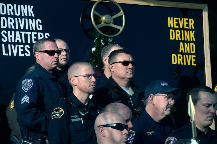 (Al Hartmann | The Salt Lake Tribune) Members of the South Jordan Police and Utah Highway Patrol stand with Jan McMillian at a press conference about the dangers of driving drunk on Thursday, Dec. 14, 2017. She described their family's loss when a drunken driver, who was driving the wrong direction on I-215, killed their adult son, Mikey, in 2015. South Jordan Police and the Utah Highway Patrol said that there will be increased patrols and enforcement over the holiday to catch drunken drivers.