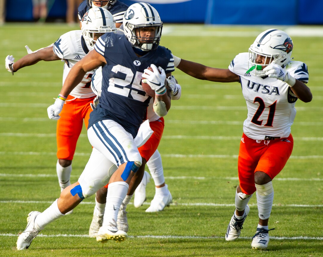 (Rick Egan  |  The Salt Lake Tribune)    Brigham Young running back Tyler Allgeier (25) runs for a Cougars as UTSA Roadrunners cornerback Ken Robinson (21) defends, in football action between the Brigham Young Cougars and the UTSA Roadrunners, at Lavell Edwards stadium, Saturday, Oct. 10, 2020.