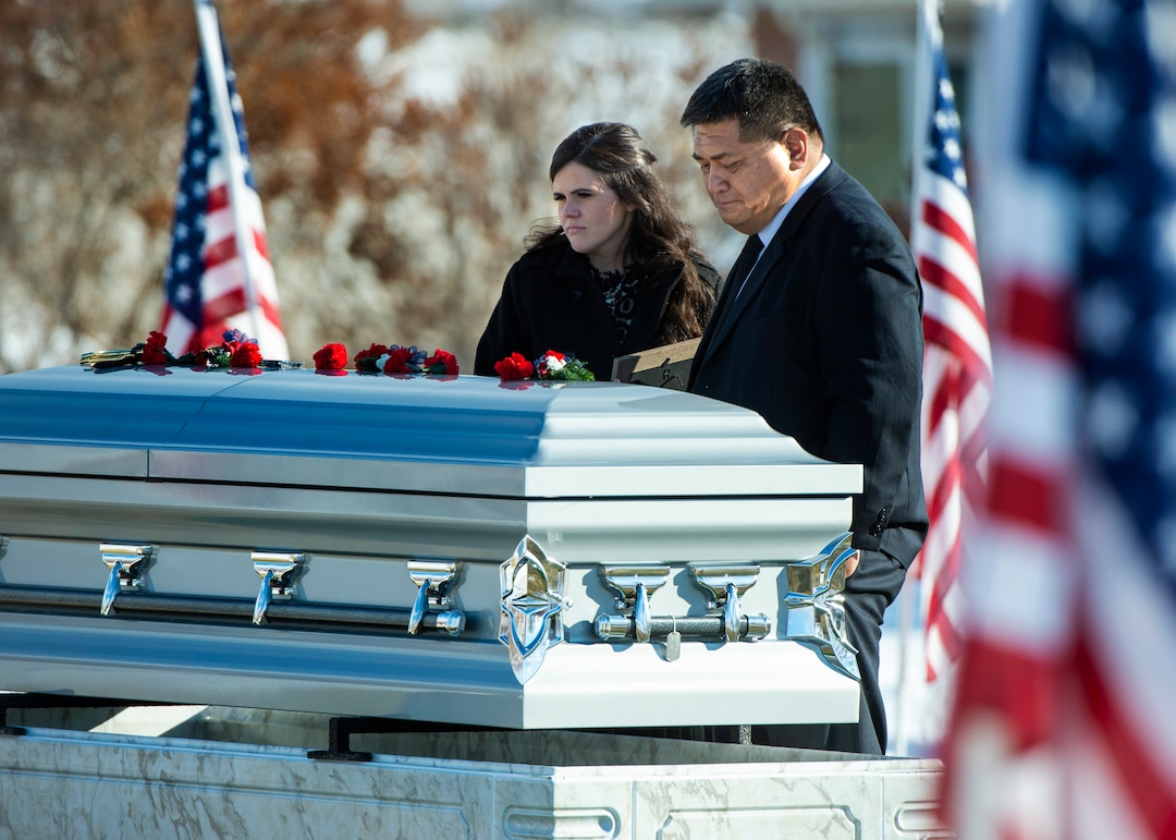 (Rick Egan  |  The Salt Lake Tribune)   McKenzie Fuchigami, stands by the casket with  Kirk T. Fuchigami Sr, after the funeral for her husband Kirk T. Fuchigami Jr. who was killed in Afghanistan, Monday, Dec. 9, 2019.