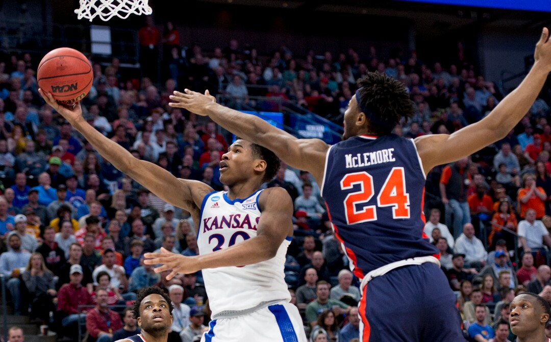 (Leah Hogsten  | The Salt Lake Tribune)  Kansas Jayhawks guard Ochai Agbaji (30) drives to the basket under pressure from Auburn Tigers forward Anfernee McLemore (24) as Auburn faces Kansas in the second round of the NCAA tournament in Salt Lake City on Saturday, March 23, 2019.