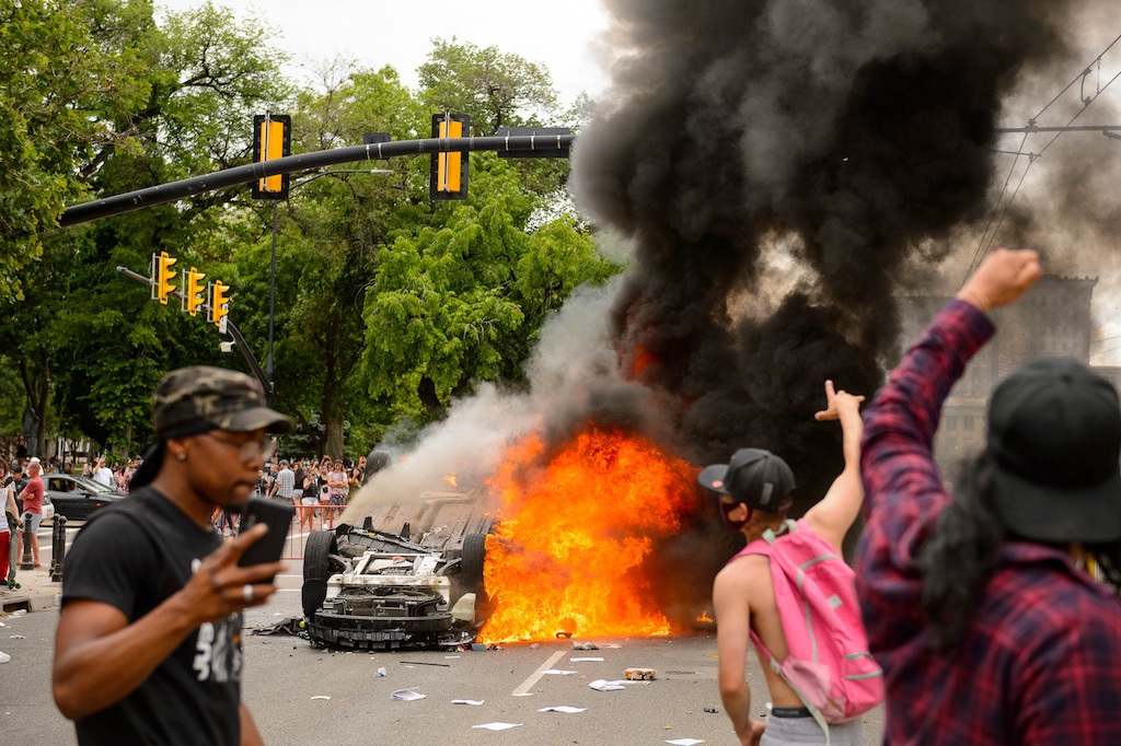 (Trent Nelson | The Salt Lake Tribune) A police car is destroyed and burned during a protest against police brutality at the State Capitol in Salt Lake City on Saturday, May 30, 2020.