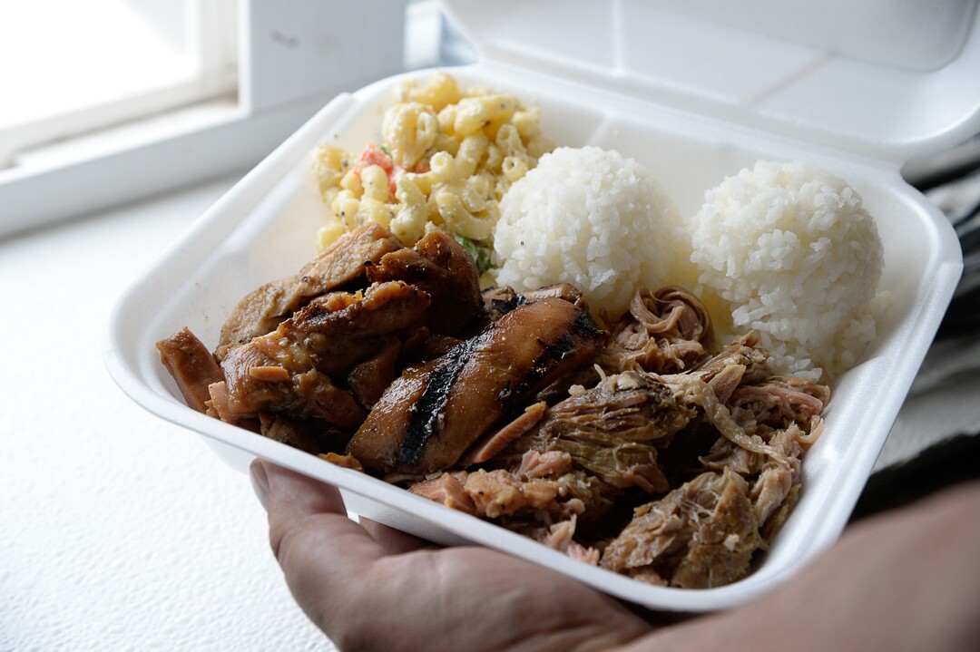 (Francisco Kjolseth  |  The Salt Lake Tribune)  Keni Aikau, owner of the Hungry Hawaiian carries on his father's recipes as he prepares a pork and chicken plate with his father's signature macaroni salad during Food Truck night at Trolley Square draws people in on Wed. July 17, 2019. Three of the vendors that showed up, along with four others will vie for the title of Best New Food Truck on Aug. 3 at the Food Truck and Brewery Battle at The Gateway.