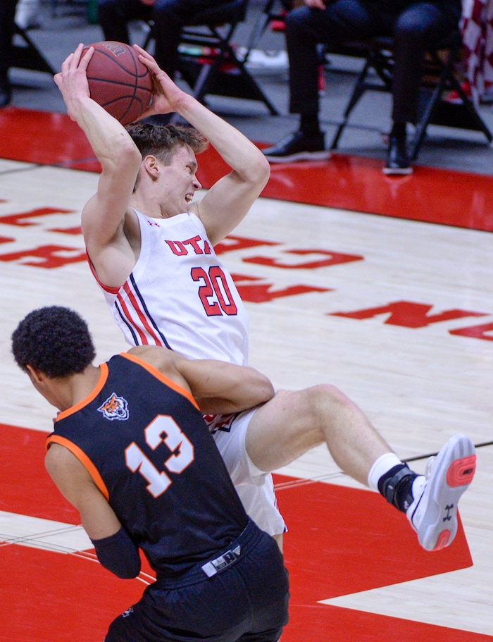 (Leah Hogsten  |  The Salt Lake Tribune) Utah Utes forward Mikael Jantunen (20) hits the deck after colliding with Idaho State Bengals forward Daxton Carr (13) pulling in the pass during their NCAA basketball matchup Tuesday, Dec. 8, 2020 at the Jon M. Huntsman Center.