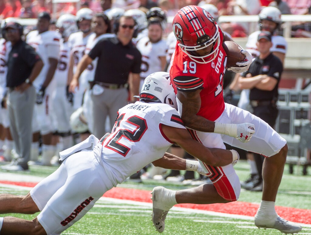 (Rick Egan  |  The Salt Lake Tribune)    Utah Utes wide receiver Bryan Thompson (19) is tackled by Northern Illinois Huskies cornerback Devin Haney (12), after catching a Tyler Huntley pass for a 38-yard gain in Utah's 35-17 win.