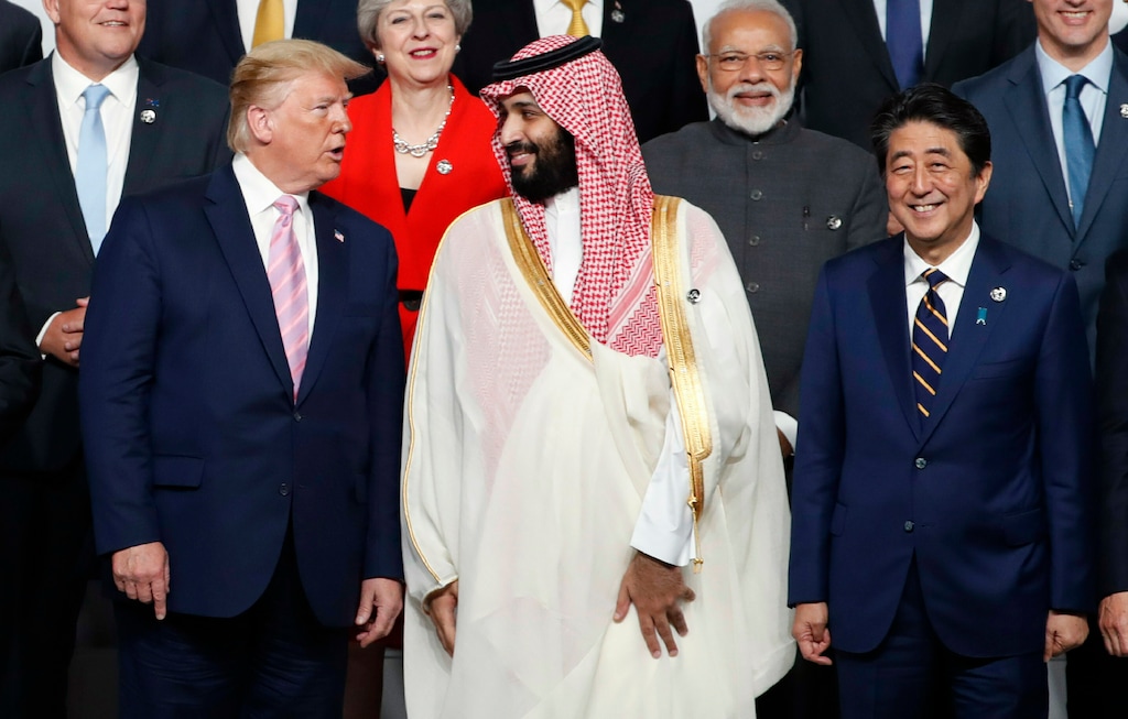 U.S. President Donald Trump, left, speaks with Saudi Arabia's Crown Prince Mohammed bin Salman during family photo session at G-20 leaders summit in Osaka, Japan, Friday, June 28, 2019. (Kim Kyung-Hoon/Pool Photo via AP)