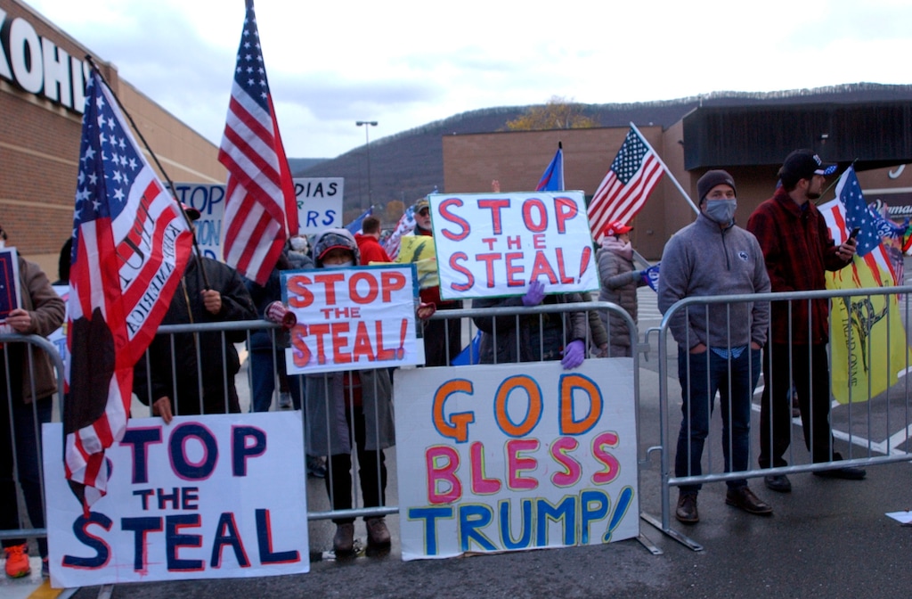 Approximately 100 Trump supporters some with flags and signs stood across West Third Street from the Federal Building in Williamsport, Pa., for hours Tuesday, Nov. 17, 2020, chanting such things as ‘Four More Years,’ ‘Black Lives Matter,’ ‘We Want Trump’ and ‘Dead People Can’t Vote.’ Attorneys for the Trump campaign organization inside the Federal Building were arguing why the state and seven county election boards were arguing should not certify the results of the general election because voters across the state were not treated the same. (John Beauge/The Patriot-News via AP)