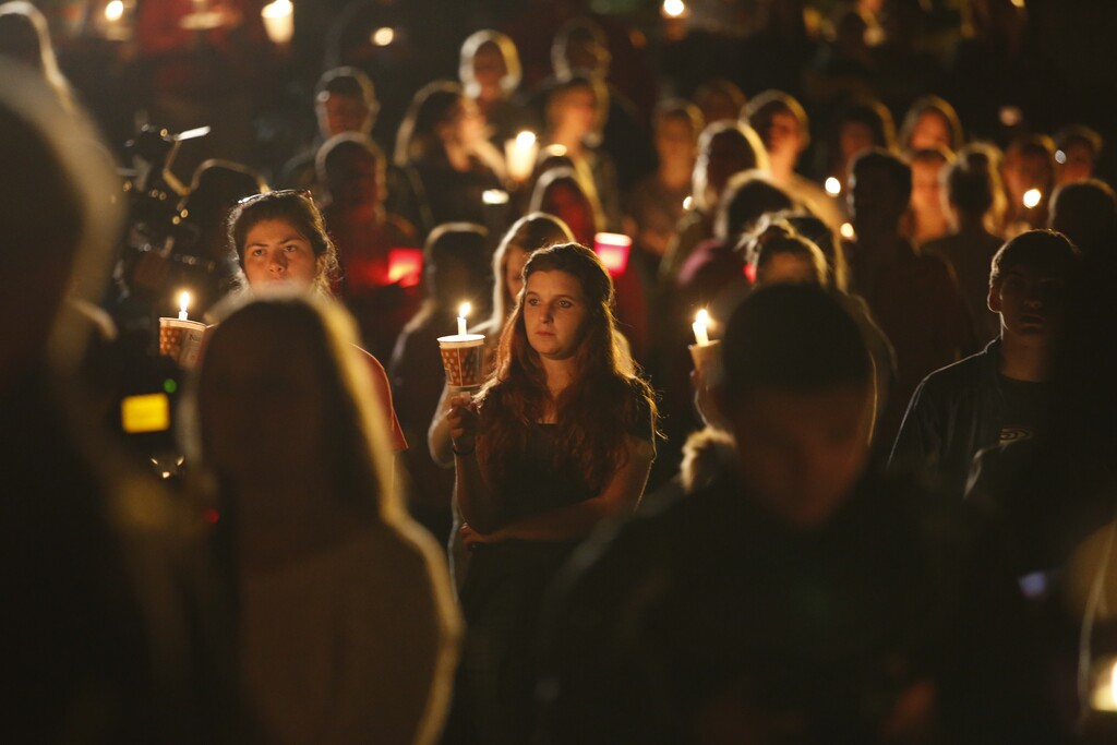 People gather for a candlelight vigil at Stewart Park in Roseburg, Ore., after a shooting with multiple fatalities occurred at Umpqua Community College, Thursday, Oct. 1, 2015. (Randy L. Rasmussen/The Oregonian via AP) 