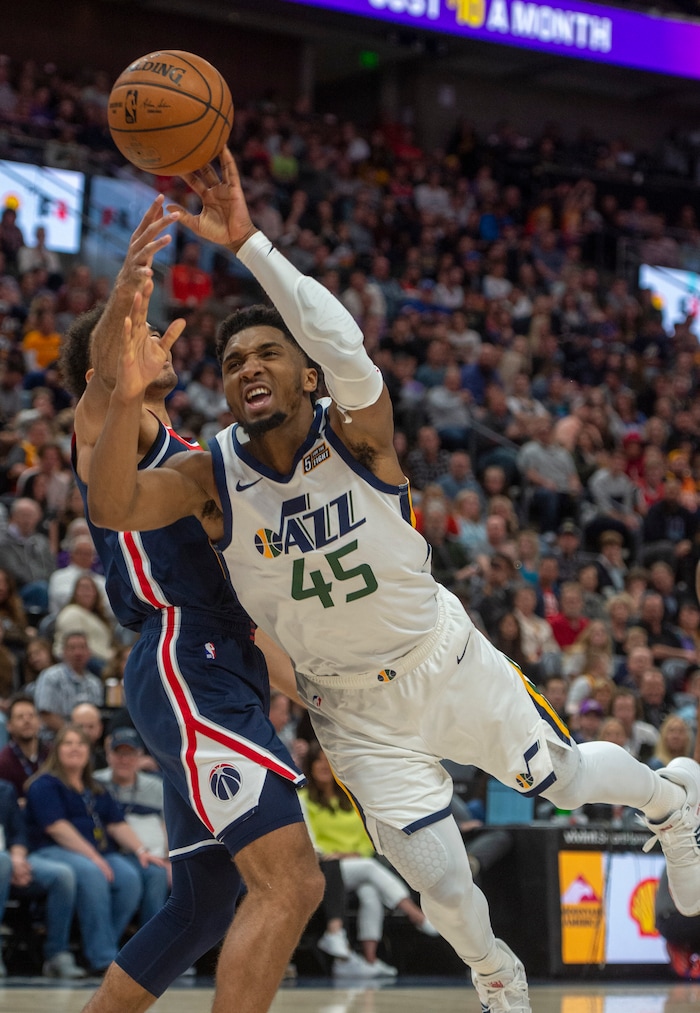 (Rick Egan  |  The Salt Lake Tribune)   Utah Jazz guard Donovan Mitchell (45) draws a foul as Washington Wizards guard Jerome Robinson (12) stops him from scoring, as he goes to the hoop, in NBA action between the Utah Jazz and the Washington Wizards, in Salt Lake City, Friday, February 28, 2020