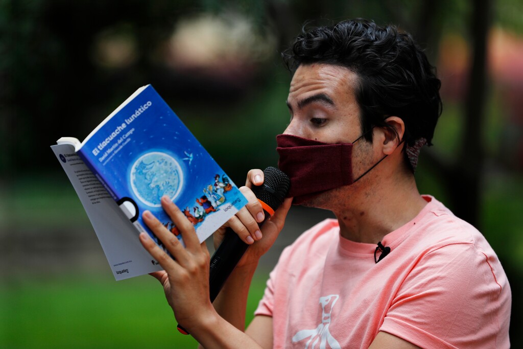 (Marco Ugarte | The Associated Press) Percibald Garcia uses a microphone to read aloud children's books amid the high-rise housing complex of Tlatelolco, in Mexico City, Saturday, July 18, 2020. Confinement during the coronavirus pandemic has been especially tedious for children, so the young architect sets out every afternoon with a microphone and a loudspeaker to walk the neighborhood where he lives and provide entertainment.