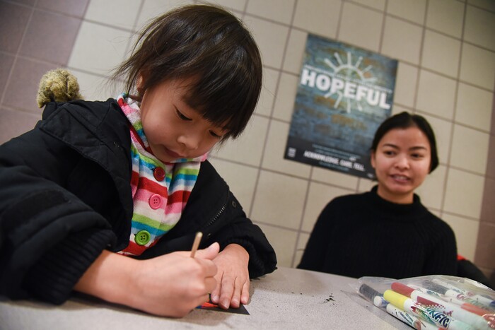 (Francisco Kjolseth  |  The Salt Lake Tribune)  Amihan Orbiso, 5, takes advantage of the kid activities alongside her mother Naro as Salt Lake City's Winter De-Stressor Festival at the Horizonte Instruction and Training Center in Salt Lake on Saturday, Dec. 15, 2018. The event helped families find services or programs for youths between Christmas and New Years.