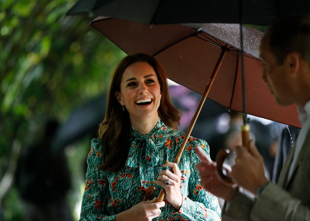 Britain's Prince William and his wife Kate, Duchess of Cambridge smile as they walk through the memorial garden in Kensington Palace, London, Wednesday, Aug. 30, 2017. Princes William and Harry are paying tribute to their mother, Princess Diana, on the eve of the 20th anniversary of her death by visiting the Sunken Garden to honor Diana's work with charities. (AP Photo/Kirsty Wigglesworth)