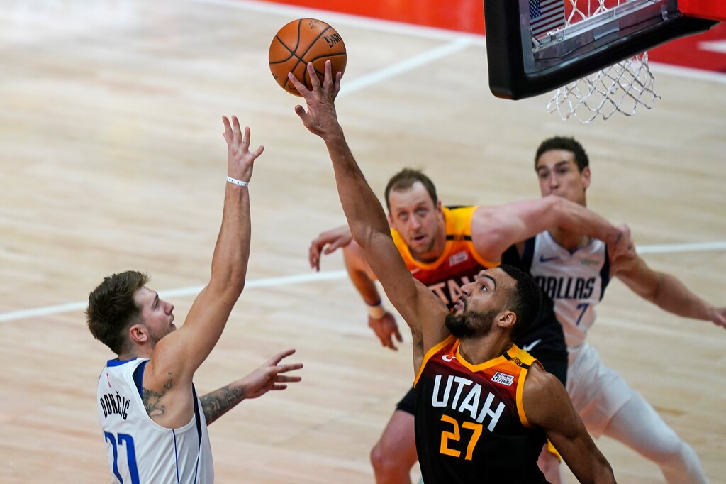 Utah Jazz center Rudy Gobert (27) blocks the shot from Dallas Mavericks guard Luka Doncic (77) during the second half of an NBA basketball game Friday, Jan. 29, 2021, in Salt Lake City. (AP Photo/Rick Bowmer)