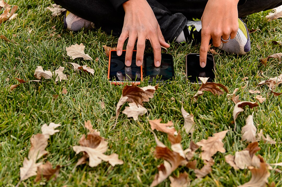 (Trent Nelson | The Salt Lake Tribune)  A Pokemon Go player uses three devices simultaneously while participating in a raid at the University of Utah in Salt Lake City on Thursday, Oct. 19, 2017.