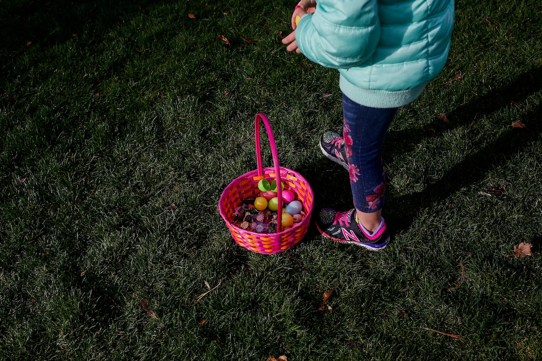 (Nicole Boliaux  |  For The Tribune)  Marina Rogers gathers Easter eggs during the annual Easter egg hunt put on by A Kid's Place Dentistry in Liberty Park in Salt Lake City on Saturday, March 31, 2018.