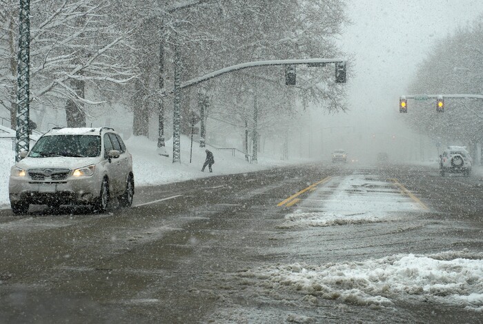 Scott Sommerdorf | The Salt Lake TribuneA man carefully navigates his way to the sidewalk on State Street in Salt Lake City after an overnight snowstorm, Sunday, March 4, 2018.