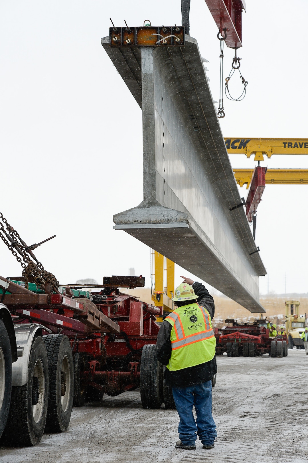 (Francisco Kjolseth  |  The Salt Lake Tribune)  UDOT gets ready to place some of the world's largest-ever bridge beams, and the largest in Utah state history with a span of 203 ft long and just over 8 ft tall, as crews load one on a truck following manufacturing at Forterra Structural Precast in Kearns on Tuesday, Dec. 11, 2018. A total of six beams will be installed in the technology corridor in Lehi later this week.