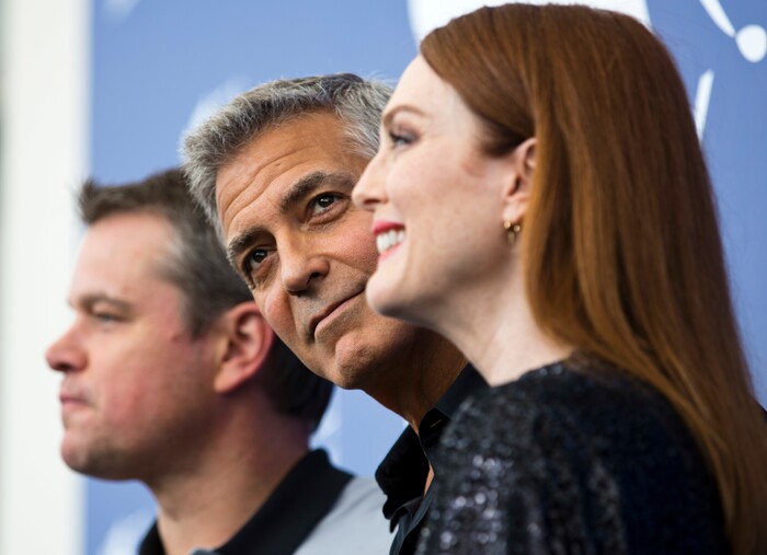 Actor George Clooney, center, poses with actors, Julianne Moore, right, and Matt Damon during the photo call for the film "Suburbicon" at the 74th Venice Film Festival in Venice, Italy, Saturday, Sept. 2, 2017. (AP Photo/Domenico Stinellis)