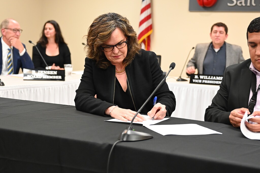 (Salt Lake City School District) Elizabeth Grant signs a contract to become the new Salt Lake City School District superintendent at a Salt Lake City board meeting on Thursday, May 4, 2023.