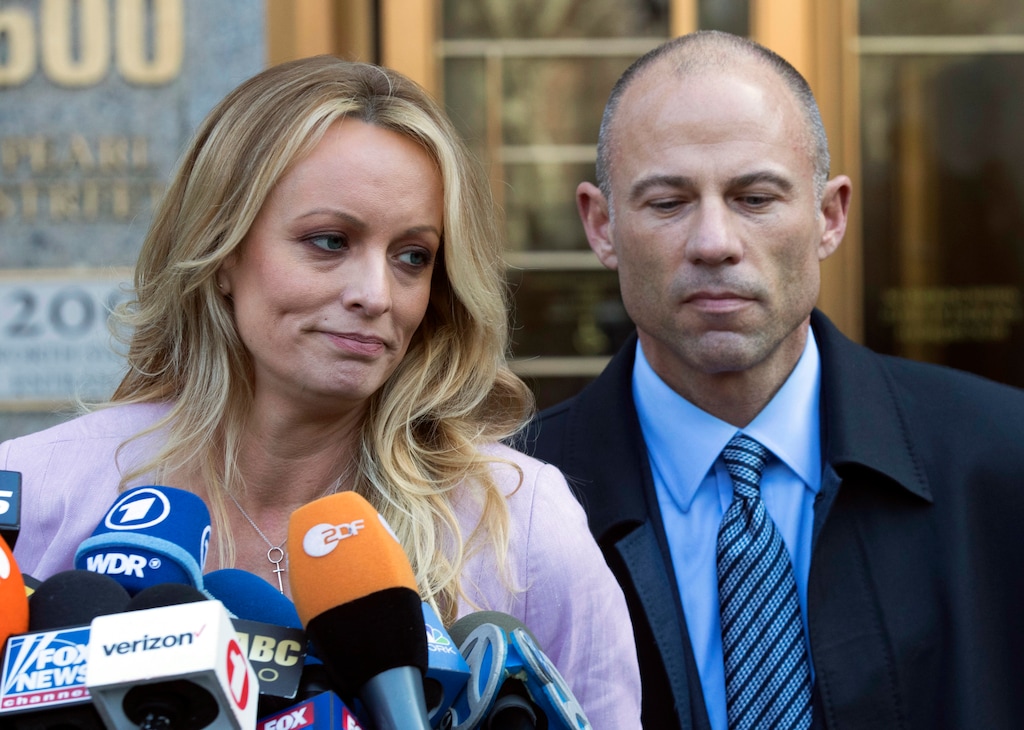 FILE - In this April 16, 2018, file photo, adult film actress Stormy Daniels, left, stands with her lawyer Michael Avenatti as she speaks outside federal court in New York. The story told by President Donald Trump and the White House about payments made to Daniels has evolved over time. The White House has consistently denied Trump had an affair with Daniels, but statements from the president and his aides about a hush money payment made just before the 2016 election have changed. (AP Photo/Mary Altaffer, File)