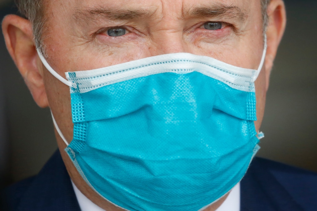 FILE - In this April 15, 2020, file photo, Utah Gov. Gary Herbert wears a mask during a news conference at Salt Lake International Airport in Salt Lake City. Utah's Republican governor says on Monday, June 22, 2020 he will not shut down the economy even though he shares some of the concerns raised in a memo by the state's epidemiologist who warned a "complete shutdown" might be imminent if the state can't stop a prolonged spike of coronavirus cases. (AP Photo/Rick Bowmer, File)
