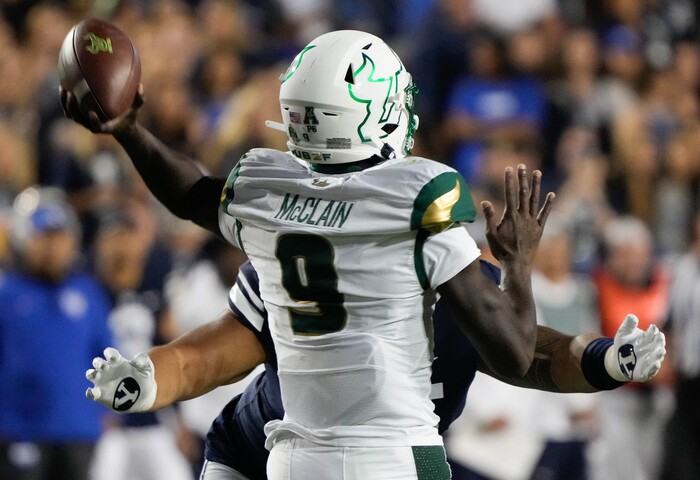 (Francisco Kjolseth | The Salt Lake Tribune) South Florida Bulls quarterback Timmy McClain (9) gets the broad arm embrace of the BYU defense in game action between the Brigham Young Cougars and the South Florida Bulls at LaVell Edwards Stadium in Provo, Saturday, Sept. 25, 2021.