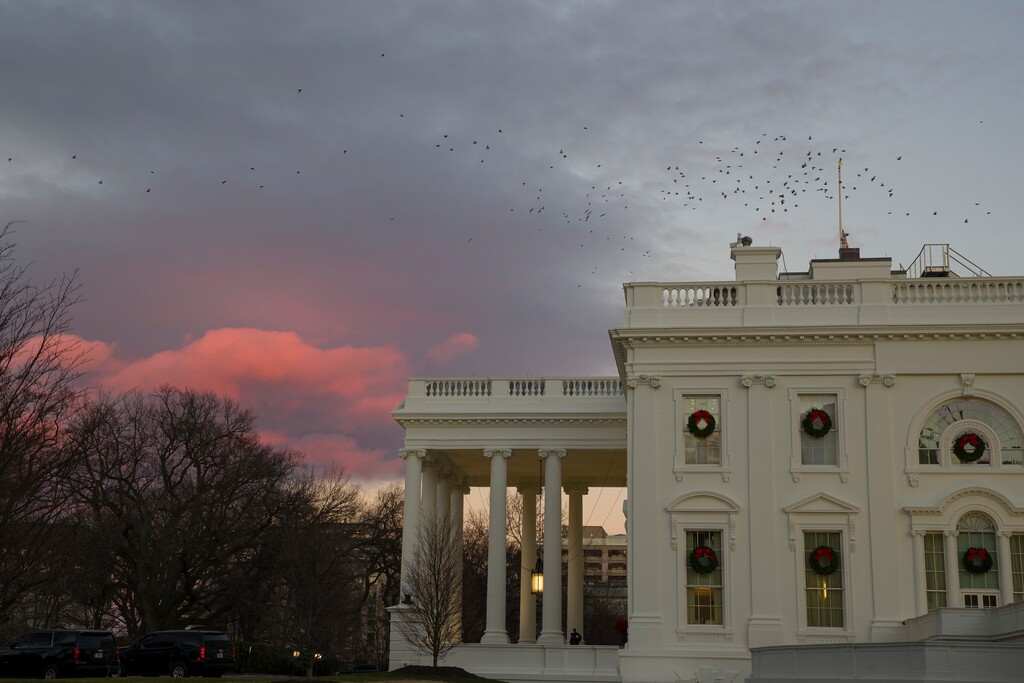 (Alex Brandon | The Associated Press) The setting sun illuminates clouds behind the White House during a partial federal shutdown, Saturday, Dec. 22, 2018, in Washington. The partial federal shutdown was expected to drag into Christmas as President Donald Trump and congressional leaders remained stuck in a standoff over his border wall with Mexico.