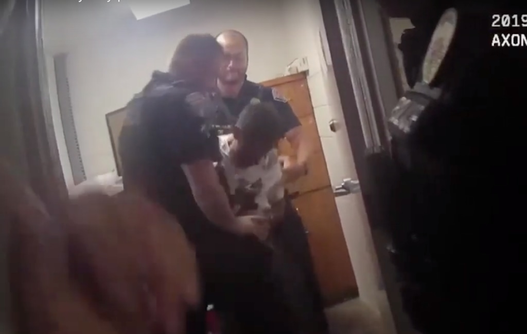 (Screen grab courtesy of West Valley City Police body camera video) Tw West Valley City police officers struggled with DUI suspect Michael Chad Breinholt after he grabs onto an officer's gun Aug. 23, 2019, in the city's DUI processing area. An officer shots and killed Breinholt shortly after.