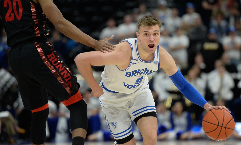 (Francisco Kjolseth  |  The Salt Lake Tribune)  Brigham Young Cougars guard Jake Toolson (5) maneuvers around UNLV Rebels forward Nick Blair (20) as BYU takes on UNLV in men's NCAA basketball at Vivint Smart Home Arena in Salt Lake City on Sat. Dec. 7, 2019.