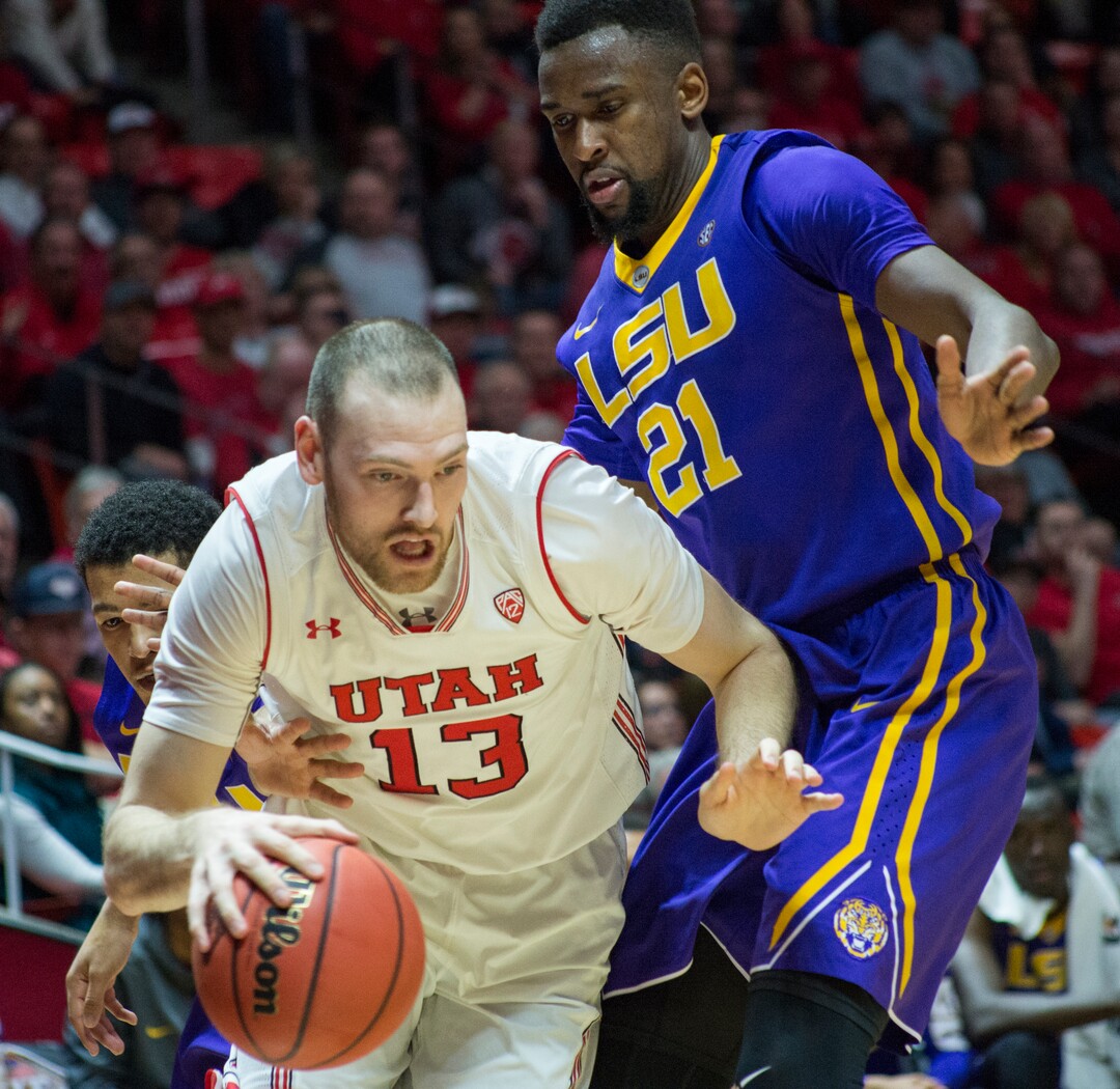 (Rick Egan  |  The Salt Lake Tribune)    LSU Tigers forward Aaron Epps (21) defends as Utah Utes forward David Collette (13) dribbles under the hoop, in NIT playoff action between Utah Utes and LSU Tigers at the Jon M. Huntsman Center, Monday, March 19, 2018.