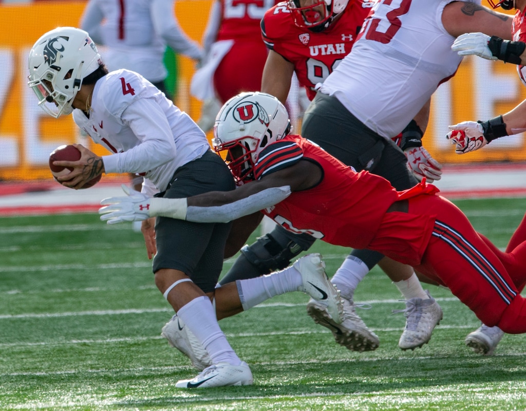 (Rick Egan | The Salt Lake Tribune) Utah Utes linebacker Devin Lloyd pulls Washington State Cougars quarterback Jayden de Laura to the ground for a sack, in Pac-12 action at Rice-Eccles Stadium on Dec. 19, 2020. Lloyd announced on Sunday, Jan. 9, 2021, that he will return to the Utes for the 2021 season.
